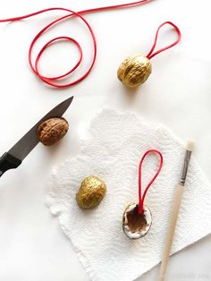 a pair of scissors and some candy on a piece of white paper with red string