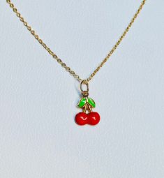 "A beautiful 14K solid yellow gold Red Cherry puffy charm / pendant with hand painted and baked enamel. It has a soldered ring to attach to a bracelet or a necklace. The small pendant measures 10mm (0.39\") tall with bail and without the soldered ring and 7.3mm (0.29\") wide. It can be used as a necklace pendant or a bracelet charm and would make a perfect gift. The pendant can be paired with a shiny 14K Yellow Gold 1.2mm cable link chain in either 16\" or 18\" length or with a 16\" 14K gold-pla Yellow Gold Enamel Round Pendant Charm Necklace, Enamel Jewelry For Gifts, Red Pendant Charm Necklace, Cute Gold Jewelry With Charms, Yellow Gold Enamel Necklace For Gift, Cute Gold Enamel Jewelry, Green Vintage Charm Jewelry For Gift, Green Vintage Charm Jewelry Gift, Everyday Handmade Enamel Jewelry