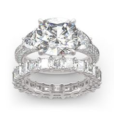 an engagement ring and wedding band set with a cushion cut diamond surrounded by baguettes