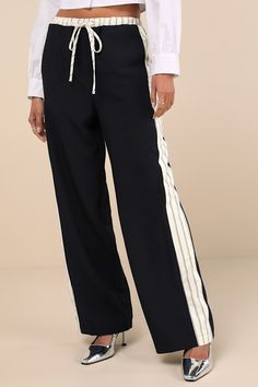 Grab your cutest kicks and a fun top and you'll have a perfect outfit to pair with the Lulus Confident Option Navy Blue Contrast Trim Side Stripe Pants! Slightly stretchy woven fabric shapes these standout pants that have a functional drawstring waist with a front tie and striped contrast trim. A matching band of striped trim creates an athletic-inspired effect as it runs down the outside edges of the straight legs, finishing at full-length hems. Fit: This garment fits true to size. Length: Floo Stretch Navy Ankle Pants, Navy Stretch Ankle-length Pants, Navy Casual Elastane Bottoms, Wide Leg Bottoms With Side Stripes For Spring, Casual Wide Leg Pants With Contrast Stripes, Sporty Elastane Pants For Summer, Relaxed Fit Wide Leg Bottoms With Side Stripes, Sporty Stretch Wide Leg Ankle-length Pants, Sporty Stretch Ankle-length Wide Leg Pants