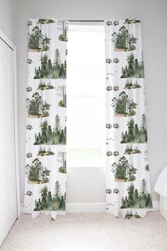 the curtains in this bedroom are drawn with trees and mountains on them, while the floor is carpeted