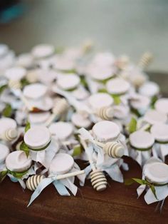 some white flowers are sitting on a wooden table and it looks like they have been made out of paper