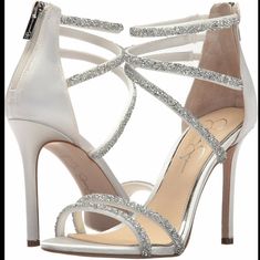 Jessica Simpson Pearl Satin & Rhinestone Jamalee Strappy Heel Sandals. Style: Js - Jamalee Color: Pearl W/ Rhinestone Available Sizes: 9m, 9.5m, 10m New Without Box - Store Closeouts May Have Been Tried On In The Store And My Have Marks On The Soles. Heel 4.25" Sweet 16 Shoes Heels Silver, Silver Shoes For Prom Wedding, Elegant Wedding Shoes Heels Silver, Bride Shoes Wedding Heels Silver, Silver Diamond Short Heels, White Glitter Shoes High Heels, Jessica Simpson Bridal Shoes, Prom Shoes Glitter, Silver Heels Prom