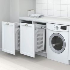 a washer and dryer in a small room with white tile flooring on the walls