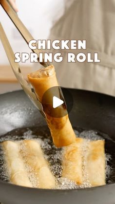 a person is frying some food in a pan with the words chicken spring roll