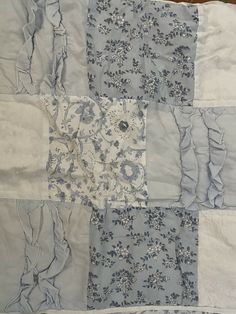 an old quilt with blue and white flowers on it