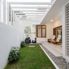 an outdoor living area with grass and rocks