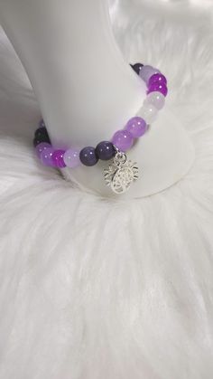 Amethyst Allure Bracelet  with Gemstone Crystal Beads, and Glass Beads, and Silver Charm. Each Charm is Random for Each Bracelet. Adjustable Purple Gemstone Beads Crystal Bracelet, Adjustable Purple Crystal Bracelet With Gemstone Beads, Adjustable Amethyst Beads For Jewelry Making, Purple Crystal Bracelet With Faceted Beads For Healing, Purple Gemstone Beads For Gift, Adjustable Purple Charm Bracelet With Round Beads, Adjustable Purple Round Beads Charm Bracelet, Purple Beaded Stretch Bracelet For Healing, Purple Round Beads Charm Bracelet