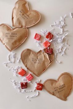 valentine's day treat bags with chocolates and candies in them on a table