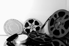 black and white photograph of film reels and other items