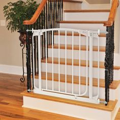 a stair gate is installed on top of the banisters in this home's entryway