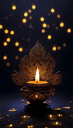 a lit candle sitting on top of a black surface with lots of lights in the background