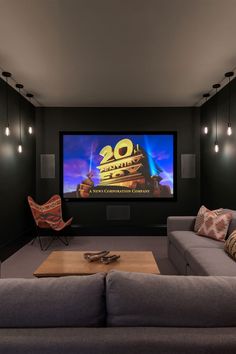 a living room filled with furniture and a flat screen tv mounted to the side of a wall