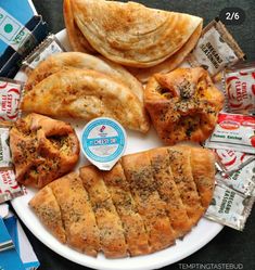 a white plate topped with different types of pastries next to candy bar wrappers