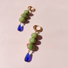 Handmade polymer clay olive earrings! Six mini olives and cobalt glass beads. Hardware is stainless steel, safe for sensitive ears and tarnish resistant. Measures 2.5 in x .5 in