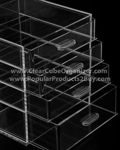 three drawers with clear plastic lids on black background