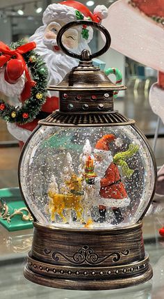 a snow globe with santa claus and other decorations