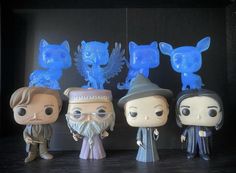 the wizard's and his friends are posed in front of some blue glass figurines