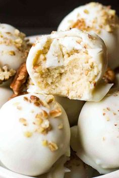 white chocolate truffles with nuts and pecans on top in a bowl