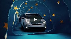 a car driving through a tunnel with stars on it