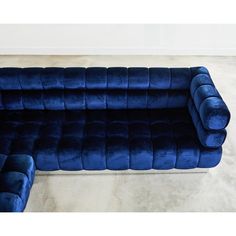 a large blue couch sitting on top of a white floor