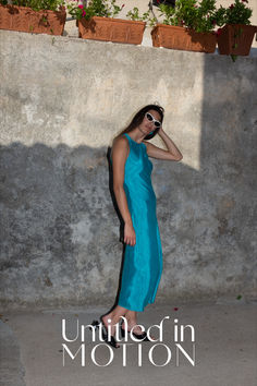 The Atlantis dress is an elegant high neck silhouette crafted from certified washed TENCEL™ with silky twill finish. Featuring UIM custom colorway Capri, this body contouring maxi length dress is cut on bias with hidden zipper closure at back of neck.

This product was created using Certified Sustainable Materials. Silk Maxi Dress With Bias Cut, Summer Full-length Bias Cut Maxi Dress, Summer Full Length Bias Cut Maxi Dress, Silk Maxi Dress With Side Slits, Bias Cut Full Length Maxi Dress For Summer, Long Satin Dress With Bias Cut, Floor-length Bias Cut Silk Summer Dress, Summer Long Silk Dress With Bias Cut, Summer Maxi Dress With Bias Cut For Evening