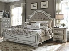 a large white bed sitting in a bedroom next to a dresser and mirror on top of a wooden floor