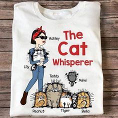 the cat whisperer t - shirt on a wooden surface