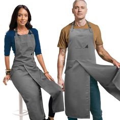 two people standing next to each other wearing aprons