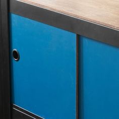 a blue cabinet with metal handles and wood top