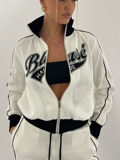 90s style tracksuit jacket and pants with embroidered logo and silver zip. Made with polyester and rib knit. Model is wearing size XS. Track Suits Aesthetic, Sporty White Track Jacket With Letter Print, White Letter Print Track Jacket For Streetwear, White Sporty Tracksuit With Letter Print, Sporty Fitted Tracksuit With Letter Print, White Moisture-wicking Track Jacket For Streetwear, Tracksuit Outfit Women, Black Sweatsuit, Track Suits Women