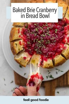 baked brie cranberry in a bread bowl on a white plate with text overlay