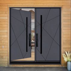 an open double door with black glass and wood paneling in front of a house