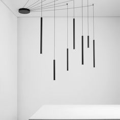 black and white photograph of suspended lights in an empty room