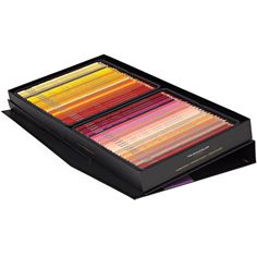 an assortment of colored pencils in a black box