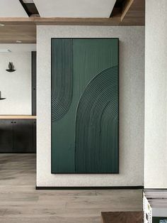 an abstract painting hangs on the wall next to a wooden table