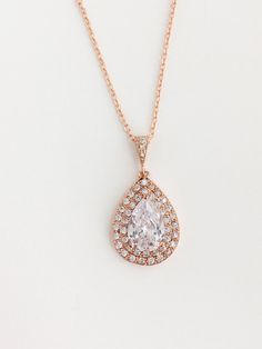 Beautiful! clear cubic zirconia bridal tear drop pendant and necklace in rose gold plated brass setting. Necklace pendant features a large teardrop with pear cut cubic zirconia center surrounded by two rows of tiny zirconia crystals which dangles from a cubic zirconia detailed bail. Length of the rose gold plated chain is 18 inches and comes with 2 inches extender and lobster clasp. For matching earrings click: https://www.etsy.com/listing/495792284/rose-gold-teardrop-crystal-earrings-rose?ref=l Rose Gold Drop Necklace For Wedding, Rose Gold Teardrop Bridal Necklace Gift, Elegant Rose Gold Teardrop Pendant Drop Necklace, Formal Rose Gold Teardrop Drop Necklace, Pear-shaped Rose Gold Cubic Zirconia Jewelry, Rose Gold Teardrop Cubic Zirconia Jewelry, Rose Gold Teardrop Drop Necklace For Wedding, Wedding Rose Gold Teardrop Drop Necklace, Rose Gold Teardrop Necklace For Anniversary