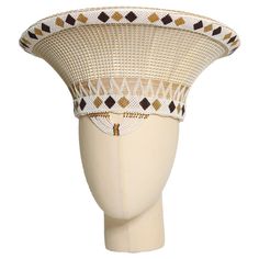 This elegant Zulu Basket Hat in white with a pattern is the perfect accessory to upgrade any outfit. This piece is handmade by female artisans in South Africa. The hat is made out of woven grass, polyester cloth patterned with cotton, wool threads, and decorative glass beads. It can be worn on special occasions like birthdays, weddings, and formal gatherings. As with all handmade items, no two pieces are the same. PRODUCT DESCRIPTION: 15" W × 7" H Head Size: 24" Elegant White Woven Hat, Isicholo Zulu Hat, Elegant White Woven Straw Hat, Traditional White Wide Brim Hat, Elegant White Woven Sun Hat, Handwoven White Brimmed Hat, White Handwoven Brimmed Hat, White Handwoven Bohemian Sun Hat, Bohemian Handwoven White Sun Hat