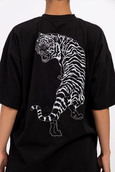 IMperfectionists Classic Tiger design on a 100% cotton textile with the perfect oversize cut. The Tiger and Copenhagen front logo are embroidered to ensure higher quality and durability. The T-shirt size is true to general EU unisex sizes. Material: 100% Deadstock Cotton Color: Black Care instruction - Wash in cold (30°C or below) water - Don't tumbledry - Iron on low heat - Don't wash together with dark or colourful clothes. Longer the use better for our environment, so please apply the followi Black Embroidered T-shirt For Streetwear, Oversized Embroidered Tops For Streetwear, Black T-shirt With Embroidered Graphics For Streetwear, Black Embroidered Graphics T-shirt For Streetwear, Trendy Black T-shirt With Front And Back Print, Oversized Graphic Tee With Embroidered Graphics, Oversized Black T-shirt With Front And Back Print, Black T-shirt With Embroidered Graphics And Relaxed Fit, Black T-shirt With Embroidered Graphics, Relaxed Fit