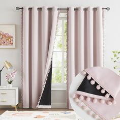 pink curtains with pom - poms hanging on them in front of a window