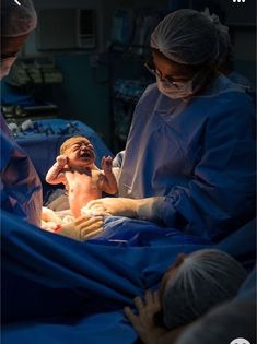 a baby is being examined by doctors in the operating room