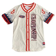 a white baseball jersey with red and blue lettering on the front, featuring an eagle