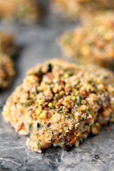 some food that is sitting on top of a stone surface with other foods in the background