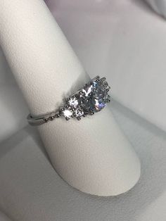 The ring is on Promotional Sale at 50% Off. Regular price for this ring is $42-$65 It is Beautiful, Incredibly Sparky Solid Sterling Silver 925 Ring With CZ Diamonds It has main 2CT Brilliant Cut Dimond and 3 (2.9mm) diamonds on each size of the main Dimond. It will not rust or turn your finger green Will come in a box (one per package). Let us know if you have specific request please **We just opened our Store here on Etsy and very Exited to introduce you to our Sterling Silver 925 Jewelry:) (A Dazzling Sterling Silver Diamond Ring, Silver Solitaire Cubic Zirconia Ring, Silver Crystal Ring With Vvs Clarity For Promise, Dazzling Sterling Silver Round Cut Crystal Ring, Silver Crystal Promise Ring With Round Stone, Dazzling Sterling Silver Diamond Ring With Round Stone, Silver Crystal Ring With Round Stone For Promise, Dazzling Sterling Silver Ring With Center Stone, Dazzling Sterling Silver Rings With Center Stone