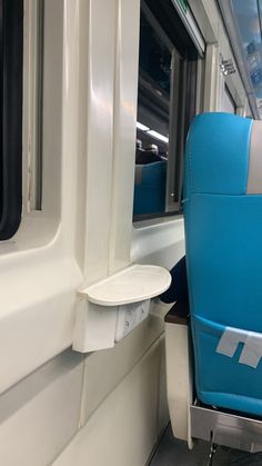 an empty seat on a train next to the window