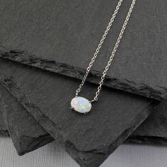 "Beautiful and lovely opal stone necklace. Made of tiny opal stone with skinny rhodium plated silver color plated chain. Simple and warm. Necklace will ship in a gift box. If you have any question, please feel free to contact me. Thanks :) ♥ Necklace 16\" long ♥ Pendent : 1/4\" x 4/16\" ♥ Rhodium plated over brass/ Opal Stone ♥ Delivery Time Fast shipping within 1 - 3 days ♥ See more Rudiana Accessories Rudiana.etsy.com" Delicate Silver Opal Necklace, Silver Opal Dainty Necklace, Silver Opal Necklace In Dainty Style, Silver Opal Minimalist Necklace, Dainty Silver Opal Necklace, Silver Necklace Layered, Necklace Opal, Layered Necklaces Silver, Necklace Layered