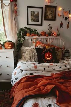 a bedroom decorated for halloween with pumpkins and decorations