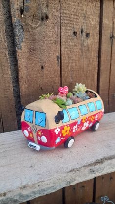 a ceramic bus planter with succulents and flowers