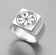 a silver ring with a compass on it