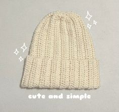 a white knitted hat with the words cute and simple written on it next to stars